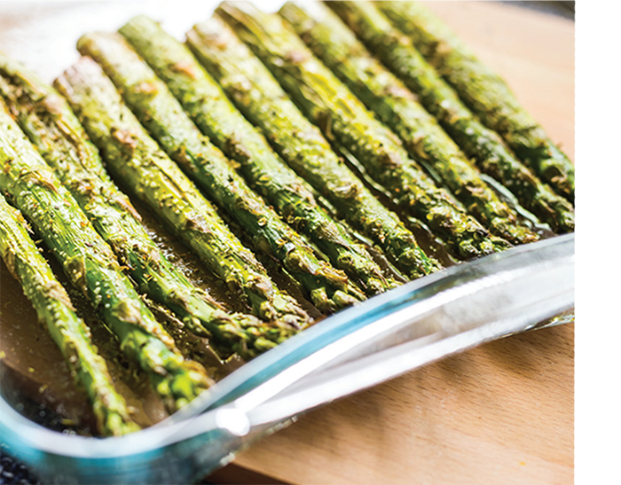 A dish holds grilled asparagus